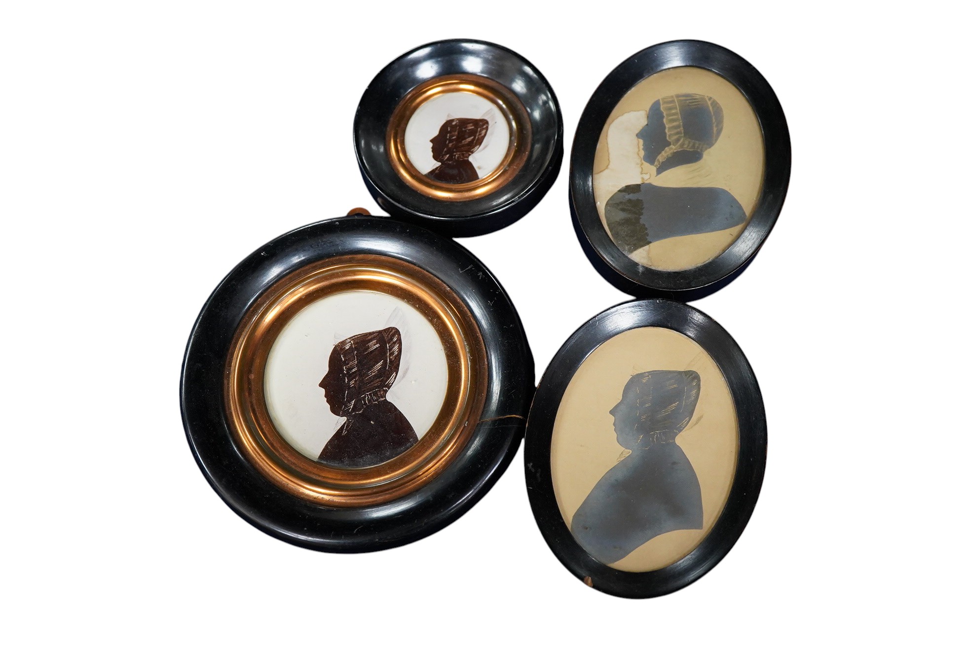 Four mid 19th century Irish hand painted silhouette portraits to include two of Sarah Woods, neé Walsh, wife of James Woods of Kilwarlin and one of Sarah Lawton, wife of Samuel Moss, largest 9.5 x 6.5cm, each framed